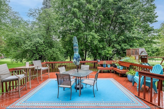 2655 Aspen Ln, Bloomfield Hills, MI 48302 - wooden deck featuring outdoor dining area and view of wooded area