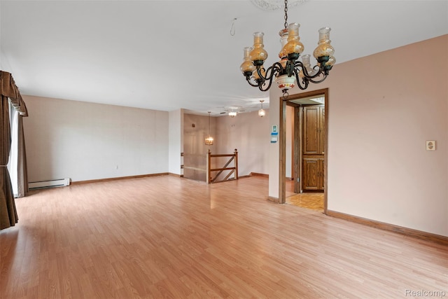 49748 Regatta St, Chesterfield, MI 48047 - unfurnished room with a baseboard radiator, light wood-style floors, a chandelier, and baseboards