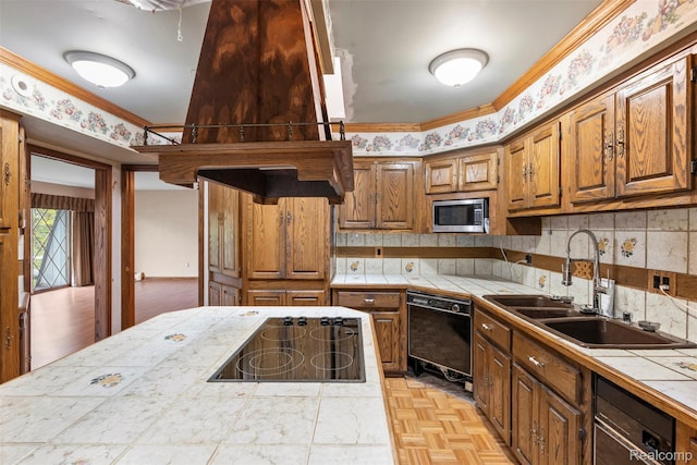 49748 Regatta St, Chesterfield, MI 48047 - kitchen featuring black appliances, tile counters, a sink, brown cabinetry, and ornamental molding