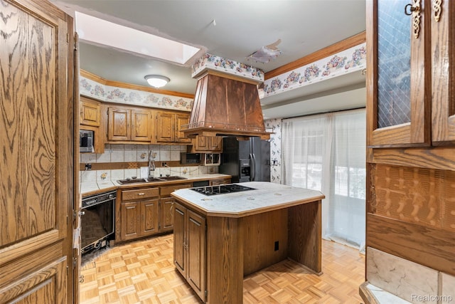 49748 Regatta St, Chesterfield, MI 48047 - kitchen with a sink, tile countertops, black appliances, and a center island