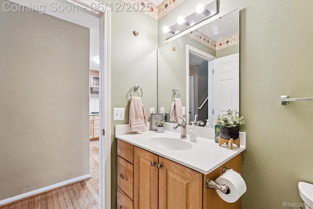 4311 Maplewood Meadows Ave, Grand Blanc, MI 48439 - bathroom featuring vanity, wood finished floors, toilet, and baseboards