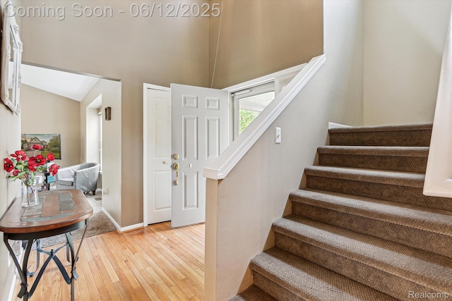 4311 Maplewood Meadows Ave, Grand Blanc, MI 48439 - foyer featuring stairway, light wood-type flooring, a towering ceiling, and baseboards