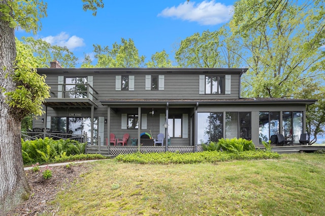 44 Bayshore Dr, Battle Creek, MI 49015 - view of front of house with a chimney, a front lawn, a sunroom, covered porch, and a balcony