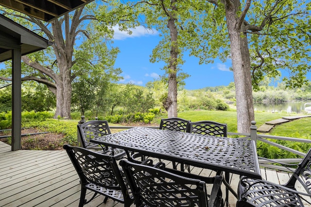 44 Bayshore Dr, Battle Creek, MI 49015 - wooden deck featuring outdoor dining area, a water view, and a lawn