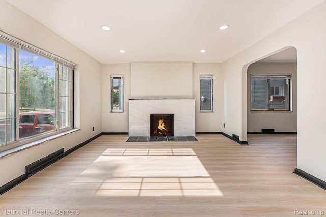18691 Greenlawn St, Detroit, MI 48221 - unfurnished living room with wood finished floors, arched walkways, recessed lighting, a fireplace, and baseboards