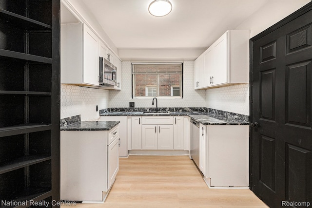 18691 Greenlawn St, Detroit, MI 48221 - kitchen with appliances with stainless steel finishes, a sink, white cabinets, and backsplash