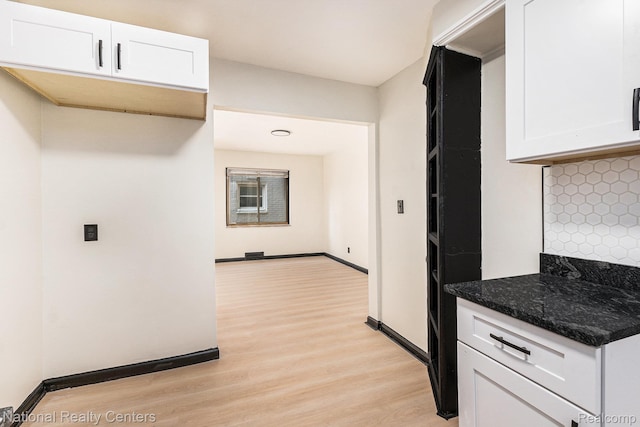 18691 Greenlawn St, Detroit, MI 48221 - kitchen with light wood finished floors, white cabinetry, decorative backsplash, dark stone counters, and baseboards