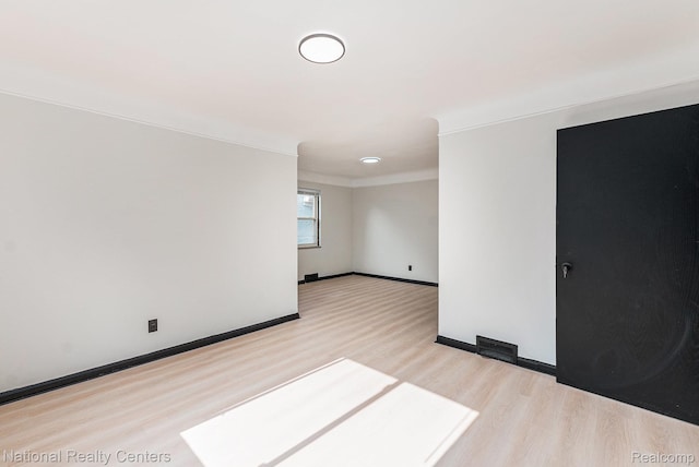 18691 Greenlawn St, Detroit, MI 48221 - empty room with light wood-style flooring, ornamental molding, and baseboards