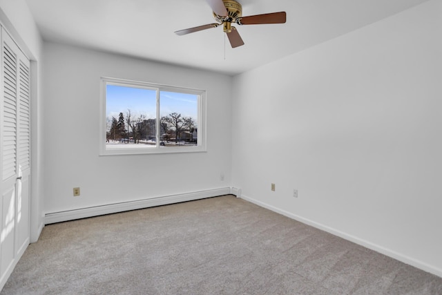 806 W Michigan Ave Unit 201E, Jackson, MI 49202 - unfurnished bedroom featuring a baseboard radiator, carpet, baseboards, and a ceiling fan