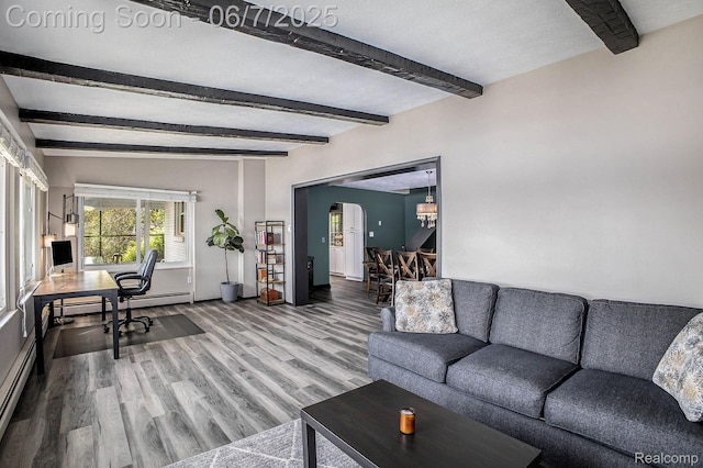 11393 Outer Dr, Pinckney, MI 48169 - living area featuring arched walkways, wood finished floors, beam ceiling, a baseboard radiator, and baseboards