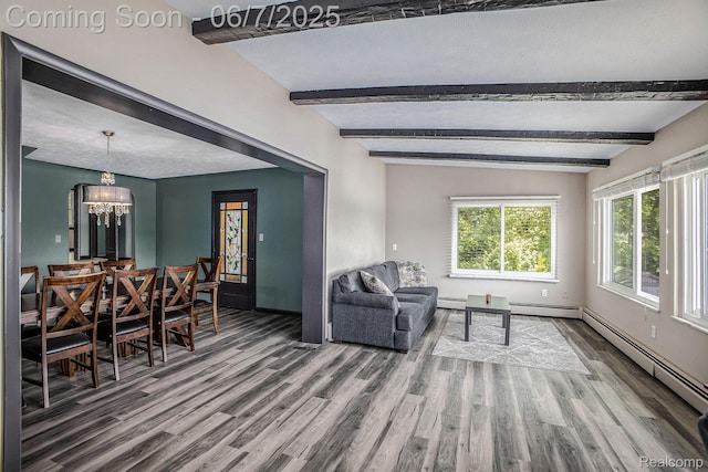 11393 Outer Dr, Pinckney, MI 48169 - living area featuring beamed ceiling, wood finished floors, a chandelier, a baseboard radiator, and baseboards