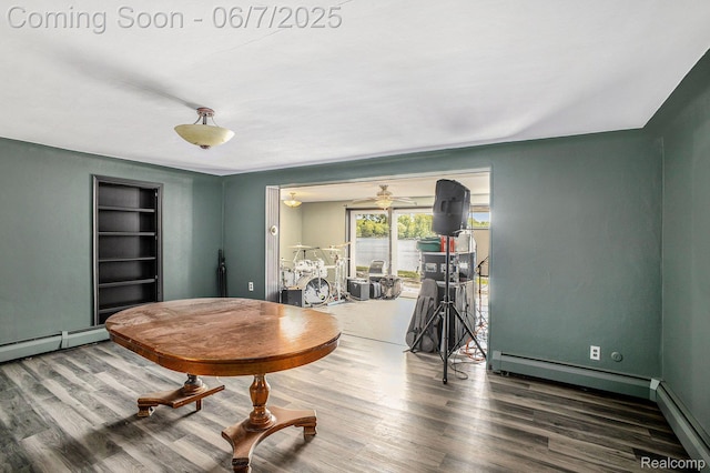 11393 Outer Dr, Pinckney, MI 48169 - dining area featuring wood finished floors, a baseboard heating unit, built in features, a ceiling fan, and baseboard heating