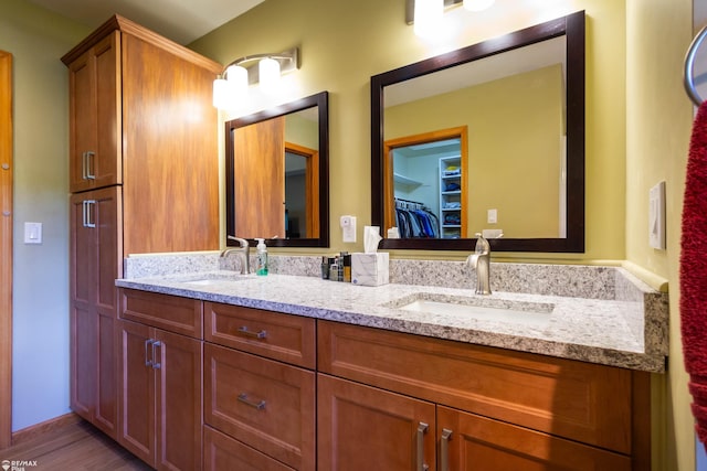 353 Golfside Dr, Lapeer, MI 48446 - bathroom featuring double vanity and wood finished floors