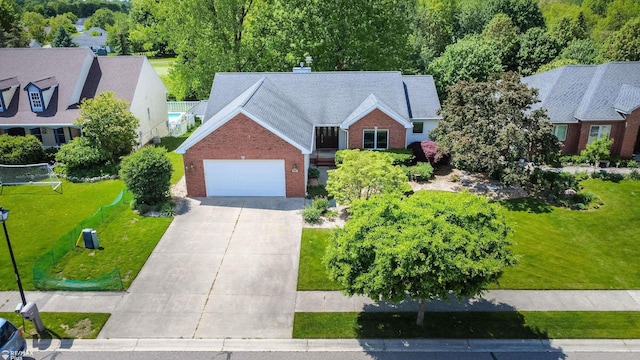 353 Golfside Dr, Lapeer, MI 48446 - view of front of house featuring brick siding, driveway, an attached garage, and a chimney