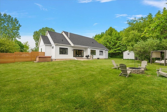 8011 Date Rd, Stevensville, MI 49127 - back of house with an outdoor fire pit, a hot tub, and a patio area