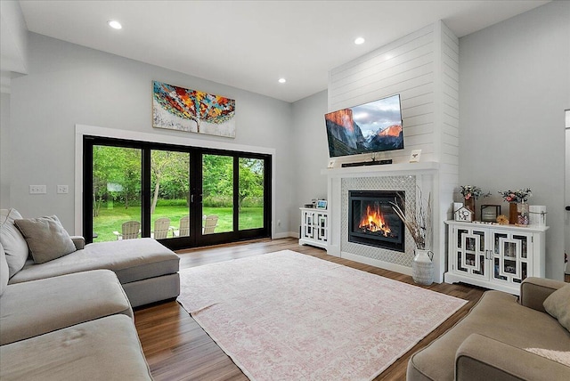 8011 Date Rd, Stevensville, MI 49127 - living area featuring a fireplace, wood finished floors, recessed lighting, a towering ceiling, and baseboards