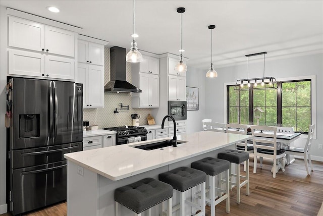 8011 Date Rd, Stevensville, MI 49127 - kitchen with stainless steel appliances, wall chimney range hood, a sink, tasteful backsplash, and white cabinetry