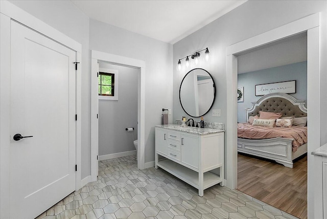 8011 Date Rd, Stevensville, MI 49127 - ensuite bathroom featuring vanity, toilet, and baseboards