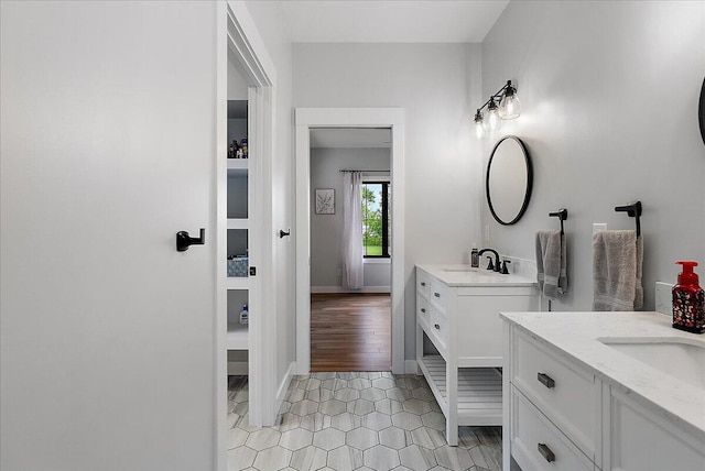 8011 Date Rd, Stevensville, MI 49127 - full bath with two vanities, tile patterned floors, and baseboards