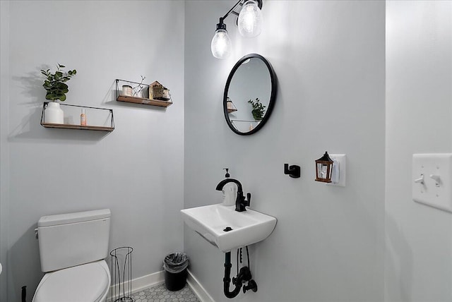8011 Date Rd, Stevensville, MI 49127 - bathroom featuring toilet, baseboards, tile patterned flooring, and a sink
