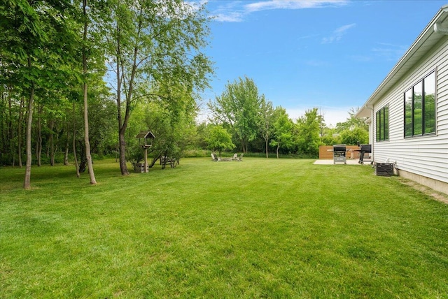 8011 Date Rd, Stevensville, MI 49127 - view of grassy yard with central AC and a patio