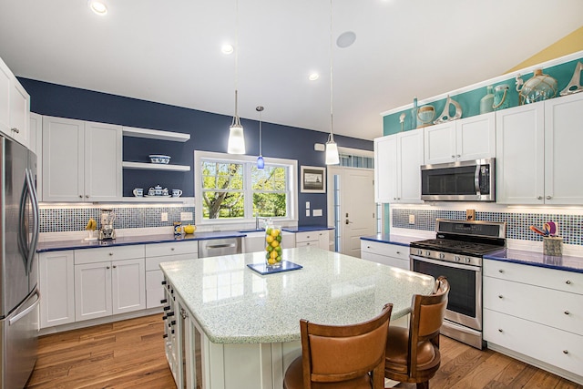 507 A Ave, South Haven, MI 49090 - kitchen featuring appliances with stainless steel finishes, a center island, decorative backsplash, white cabinets, and recessed lighting