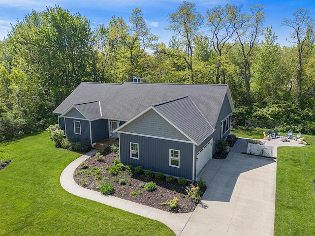 507 A Ave, South Haven, MI 49090 - view of property exterior with driveway, an attached garage, a yard, and a wooded view