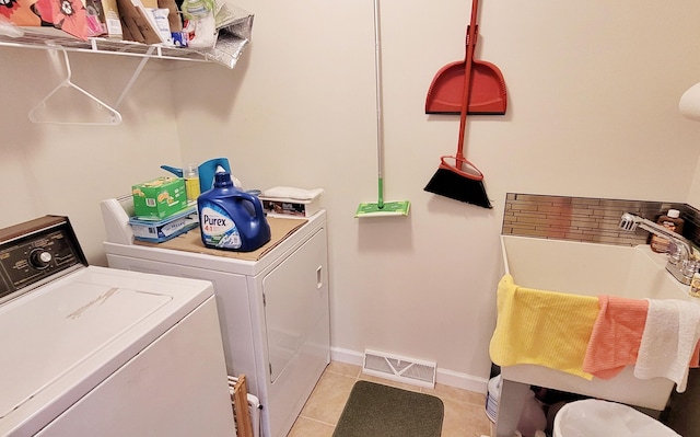 908 W Oak St, Bitely, MI 49309 - laundry area featuring washer and dryer, light tile patterned flooring, and baseboards
