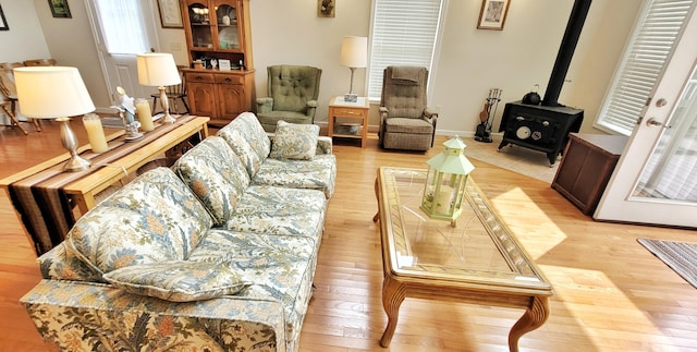 908 W Oak St, Bitely, MI 49309 - living area with a wood stove, light wood finished floors, and baseboards