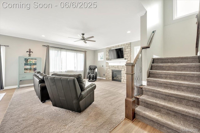 343 Hidden Riv E, Holly, MI 48442 - living room with crown molding, stairs, ceiling fan, a stone fireplace, and light wood-style floors