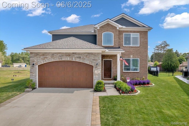 343 Hidden Riv E, Holly, MI 48442 - traditional home featuring a garage, concrete driveway, stone siding, a shingled roof, and brick siding