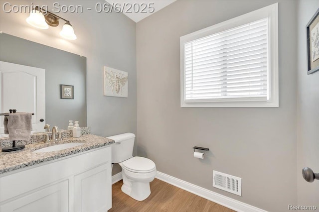 343 Hidden Riv E, Holly, MI 48442 - half bath with baseboards, toilet, wood finished floors, and vanity