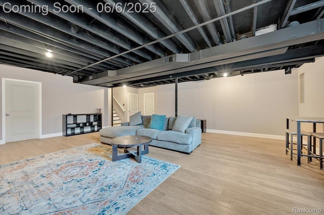 343 Hidden Riv E, Holly, MI 48442 - living room with baseboards, light wood-style floors, and stairs