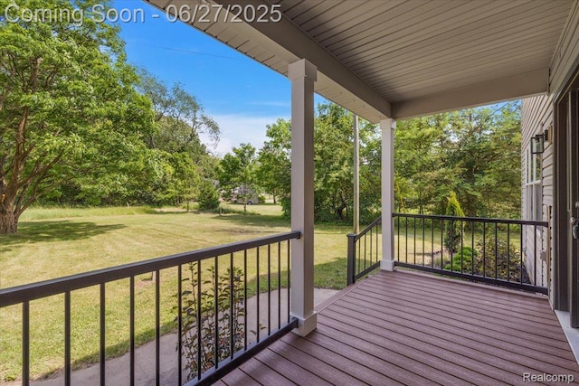 9248 Riverside Dr, Brighton, MI 48116 - wooden porch featuring a lawn and view of wooded area