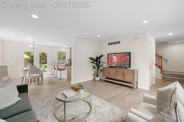 9248 Riverside Dr, Brighton, MI 48116 - living area with recessed lighting, light wood-type flooring, stairway, and a chandelier