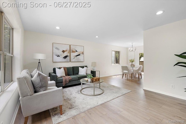 9248 Riverside Dr, Brighton, MI 48116 - living room featuring a chandelier, wood finished floors, and recessed lighting