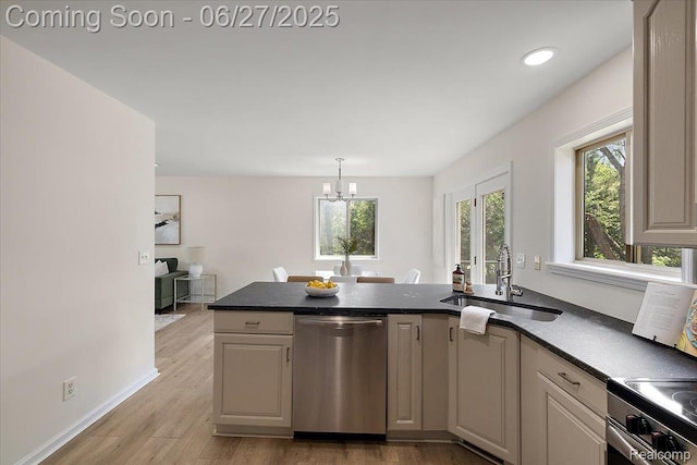 9248 Riverside Dr, Brighton, MI 48116 - kitchen featuring appliances with stainless steel finishes, a peninsula, light wood-type flooring, dark countertops, and a chandelier