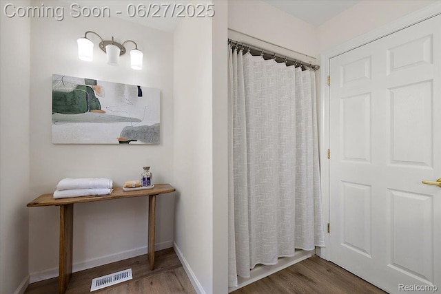9248 Riverside Dr, Brighton, MI 48116 - bathroom featuring wood finished floors and a shower with shower curtain