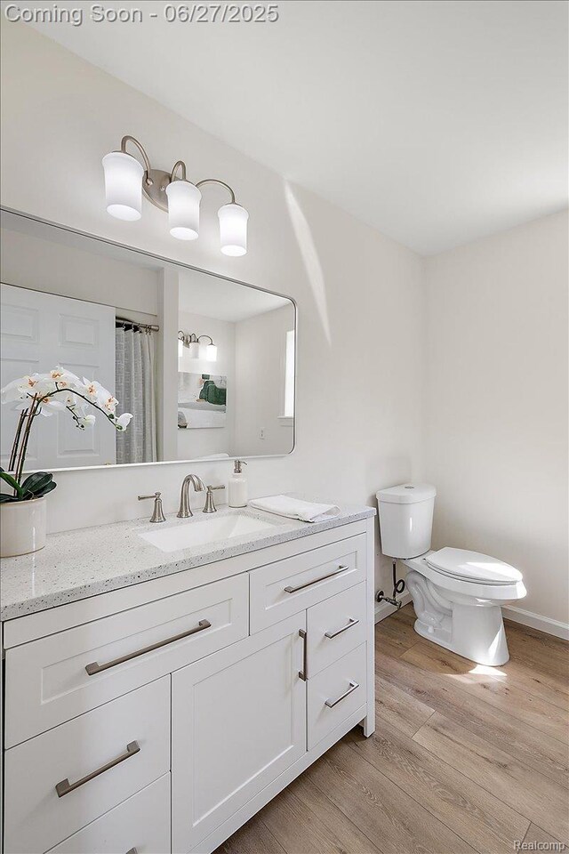 9248 Riverside Dr, Brighton, MI 48116 - full bathroom featuring vanity and wood finished floors