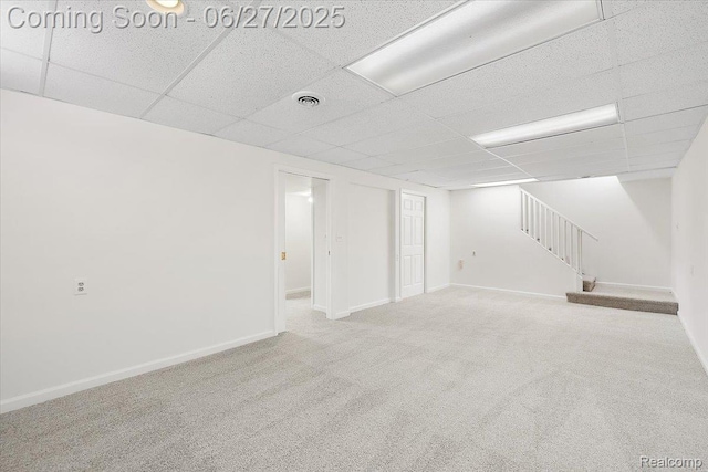 9248 Riverside Dr, Brighton, MI 48116 - finished below grade area featuring stairway, carpet, and a paneled ceiling