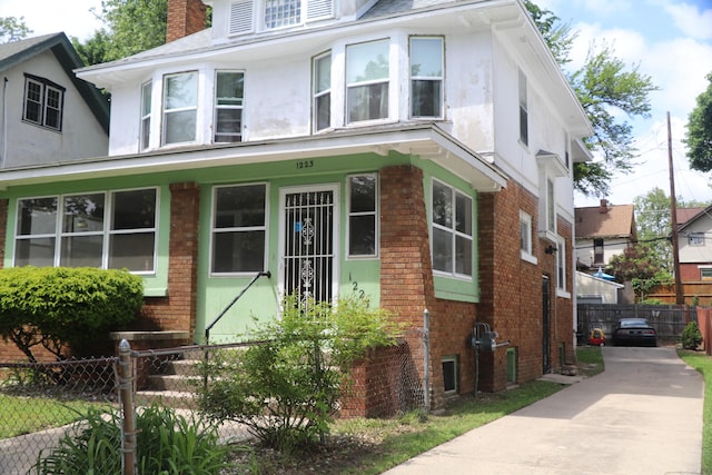1223 Bemis St SE, Grand Rapids, MI 49506 - american foursquare style home with brick siding, stucco siding, and a chimney