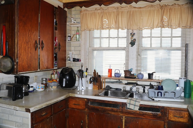 1223 Bemis St SE, Grand Rapids, MI 49506 - kitchen featuring light countertops, decorative backsplash, and a sink