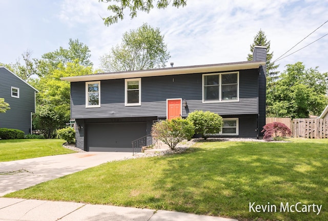 1731 Edgewood Ave SE, Grand Rapids, MI 49506 - bi-level home with concrete driveway, an attached garage, and a chimney