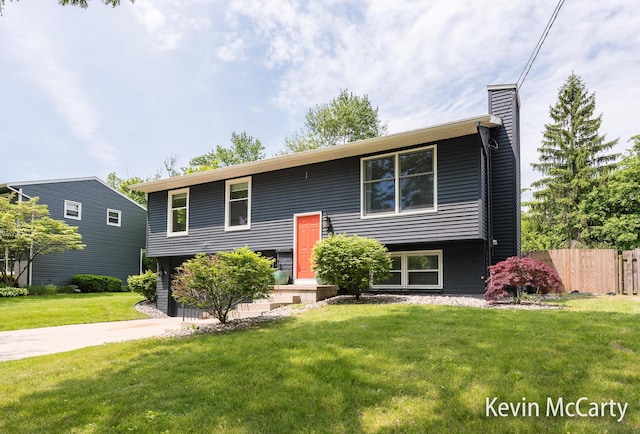 1731 Edgewood Ave SE, Grand Rapids, MI 49506 - split foyer home featuring a chimney, driveway, and a garage