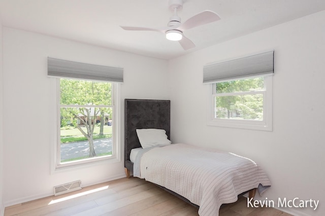 1731 Edgewood Ave SE, Grand Rapids, MI 49506 - bedroom with multiple windows, wood finished floors, and ceiling fan