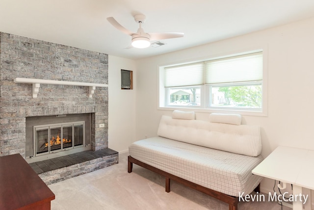 1731 Edgewood Ave SE, Grand Rapids, MI 49506 - carpeted living room featuring a ceiling fan and a stone fireplace