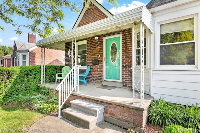 22601 Colony St, Saint Clair Shores, MI 48080 - doorway to property featuring covered porch and brick siding