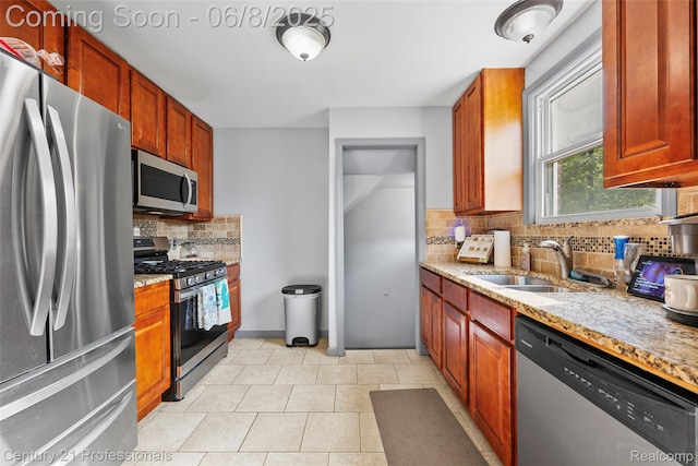22601 Colony St, Saint Clair Shores, MI 48080 - kitchen with stainless steel appliances, a sink, backsplash, light stone counters, and light tile patterned flooring