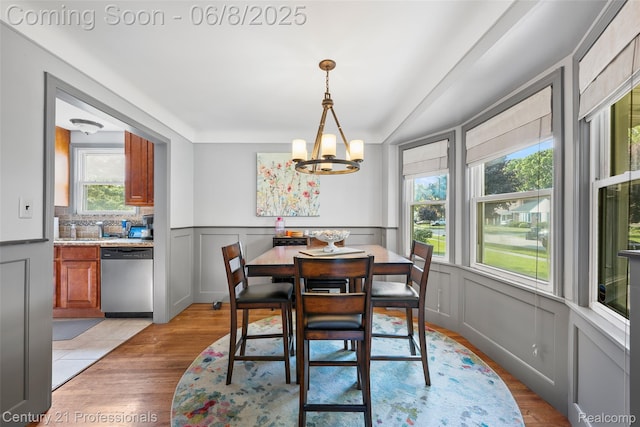 22601 Colony St, Saint Clair Shores, MI 48080 - dining space with a decorative wall, a chandelier, light wood-style floors, and a wainscoted wall
