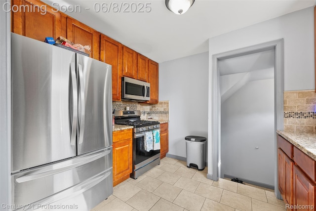 22601 Colony St, Saint Clair Shores, MI 48080 - kitchen featuring appliances with stainless steel finishes, tasteful backsplash, brown cabinets, light stone counters, and light tile patterned floors
